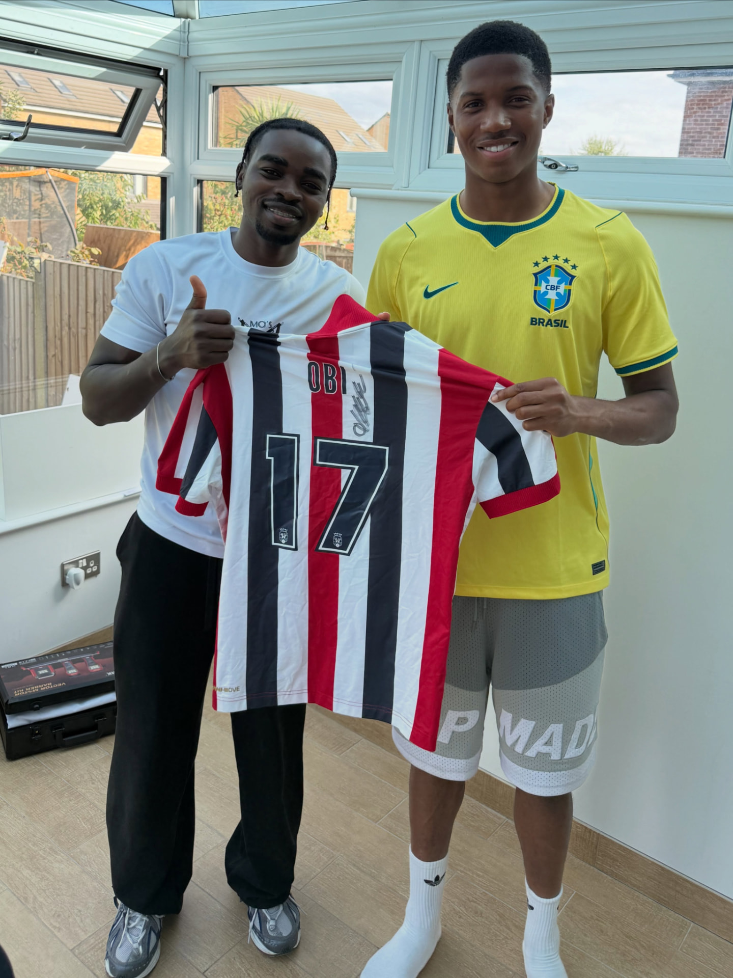 Mo standing with Danish footballer Chido Obi in Spain