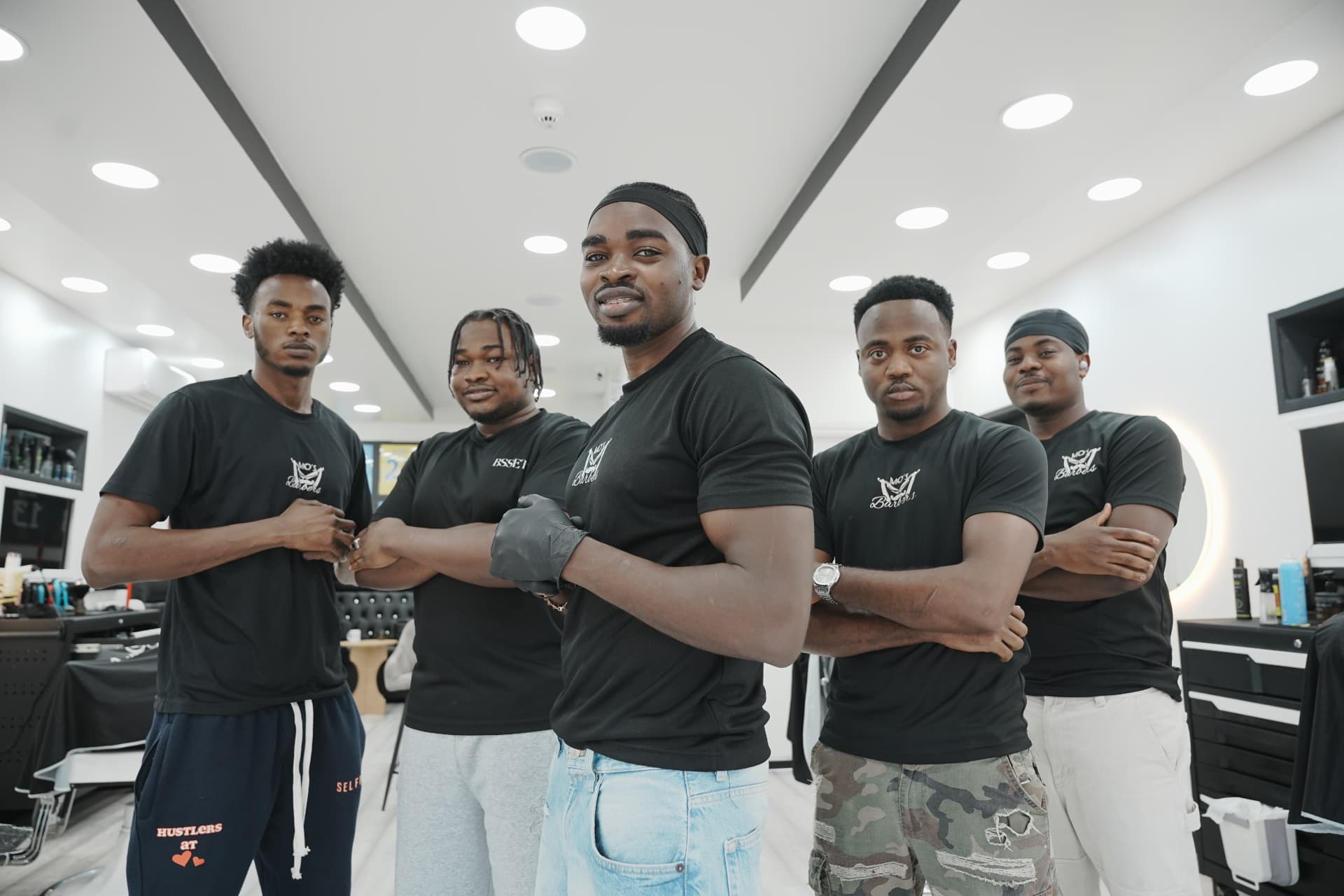 The Mo's Barbers barbers lined up in the shop